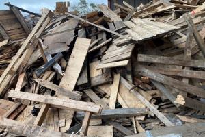A large pile of wood, which has been dismantled from products like pallets