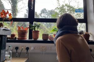 Student Chiara looking at plants on a windowsill
